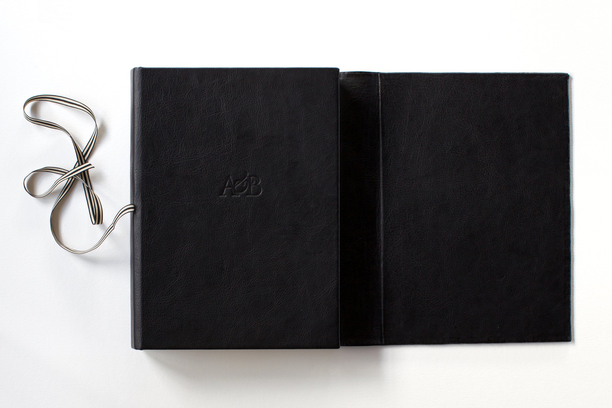 Hand-bound leather Queensberry album tied with grosgrain ribbon