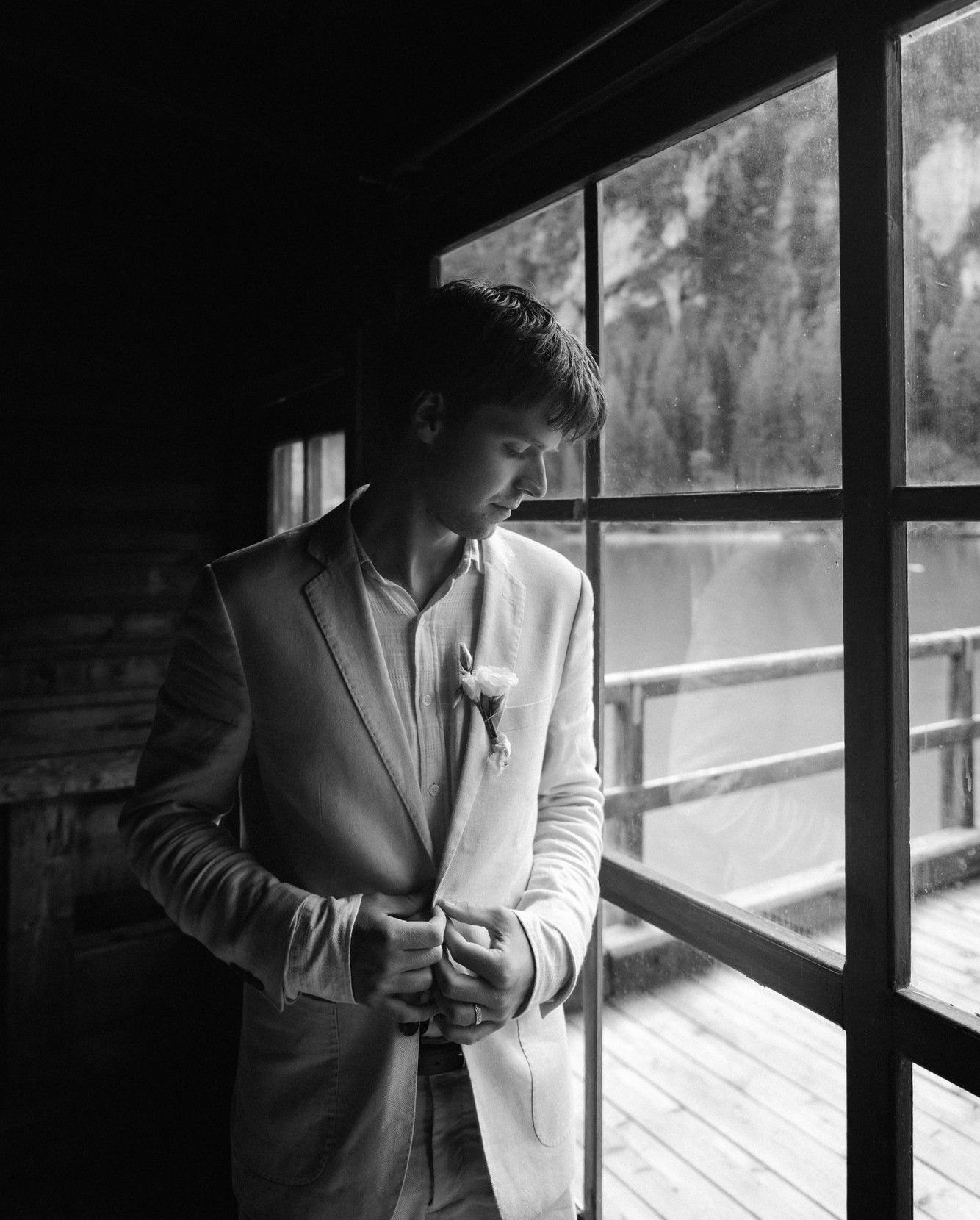 Groom fastening his jacket