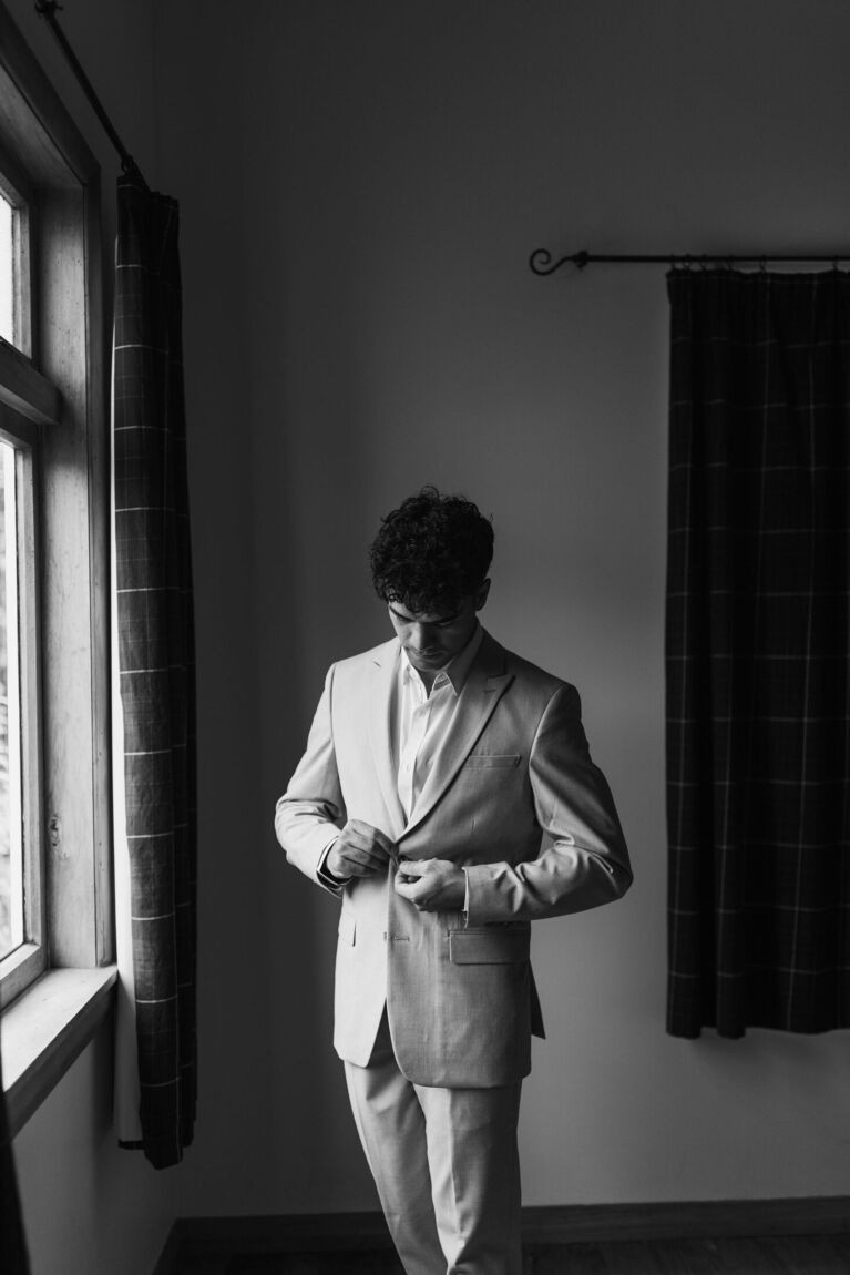 Groom getting ready by the window
